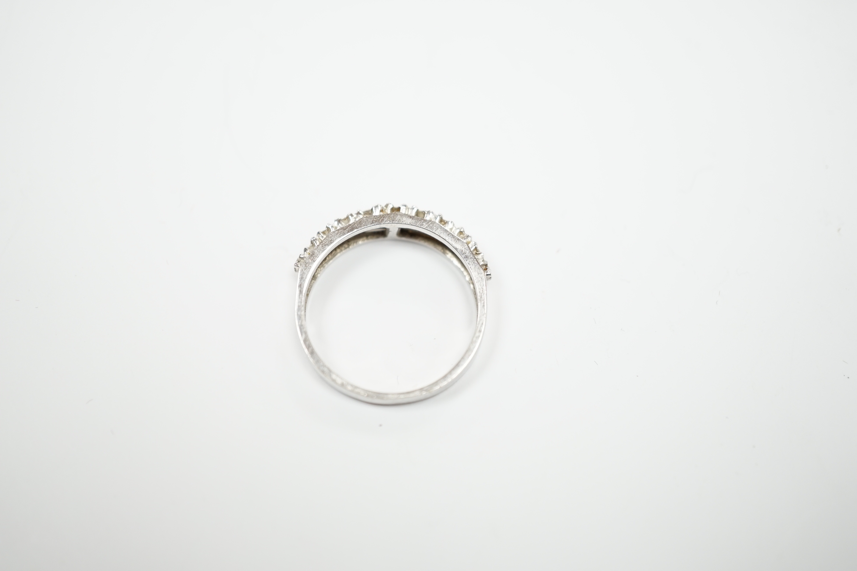 An 18ct white gold and diamond chip set half eternity ring, size M, gross weight 2.8 grams.